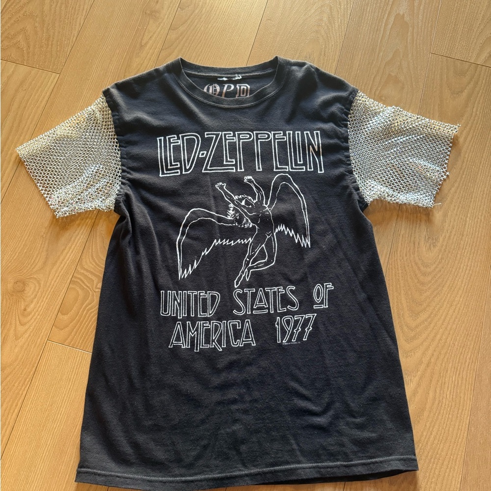 Woman’s Black Graphic Tee with Mesh Sleeves
v